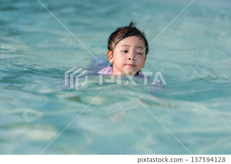 preschool child girl playing and swimming in pool 137594128