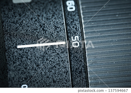 Detailed view of the focus ring and focal length markers on a professional black camera lens barrel 137594667