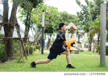 A man performs a lunge stretch outdoors, extending his leg to stretch the hip flexors and quadriceps while improving flexibility and balance. A man performs a lunge stretch outdoors, extending his leg to stretch the hip flexors and quadriceps while improving flexibility and balance. 137594996