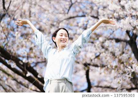 Young woman stretching under a cherry tree Lifestyle image Young woman stretching under a cherry tree Lifestyle image 137595303