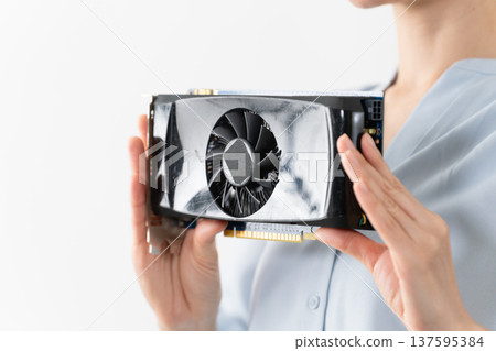 Woman holding a graphics card Technology image 137595384