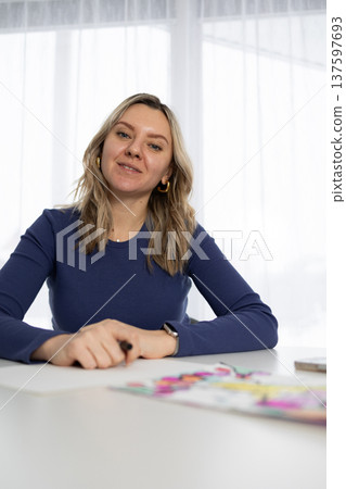 Blonde Woman Sits at Table During Session of Neurography Art Therapy Blonde Woman Sits at Table During Session of Neurography Art Therapy 137597693