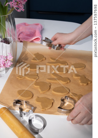 Preparing Festive Easter Gingerbread Cookies on a Kitchen Countertop 137597698