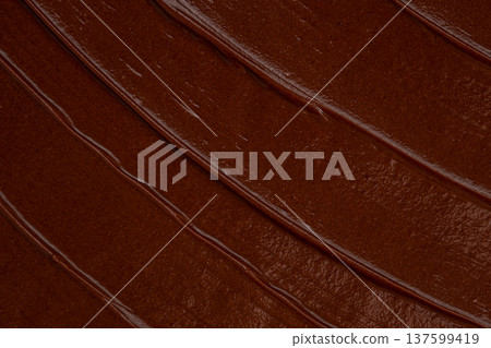 Smooth chocolate spread texture with glossy cocoa cream background Smooth chocolate spread texture with glossy cocoa cream background 137599419