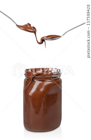 Chocolate spread dripping from spoons into jar isolated on white background Chocolate spread dripping from spoons into jar isolated on white background 137599428