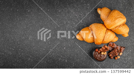 Croissants with chocolate spread and hazelnut chocolate on stone background with copy space 137599442