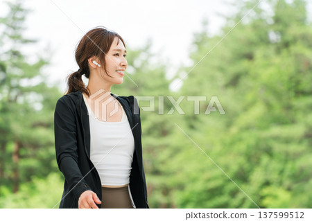 Asian woman in sportswear strolling, walking, running in the park 137599512