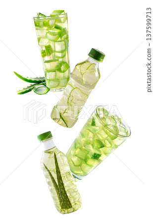 Multiple glasses and bottles with green aloe drink and cubes isolated on white background, concept of freshness Multiple glasses and bottles with green aloe drink and cubes isolated on white background, concept of freshness 137599713