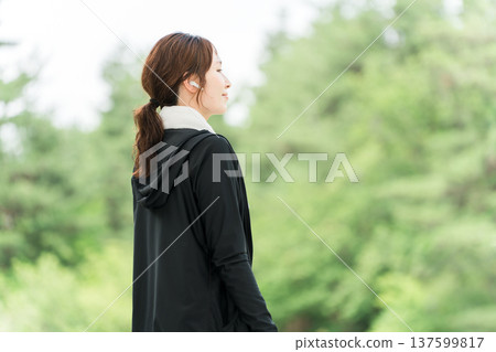 Woman running, walking, jogging, exercising (diet, sports) with earphones in the park Woman running, walking, jogging, exercising (diet, sports) with earphones in the park 137599817