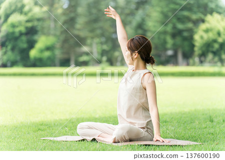 Young Asian woman doing park yoga, yoga, pilates, stretching in forest/park Young Asian woman doing park yoga, yoga, pilates, stretching in forest/park 137600190