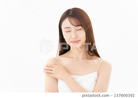 Beauty image of a woman doing skin care on a white background 137600392