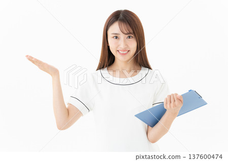 Young female esthetician on white background 137600474