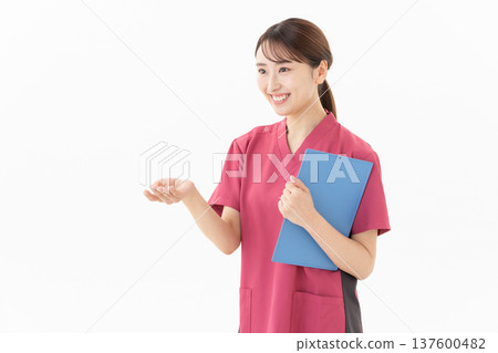 A young female doctor on a white background A young female doctor on a white background 137600482