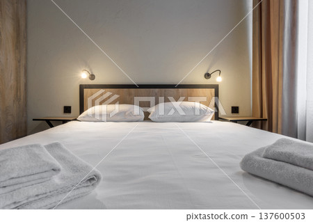 Symmetric Double Bed View in Modern Minimalist Hotel Room Symmetric Double Bed View in Modern Minimalist Hotel Room 137600503