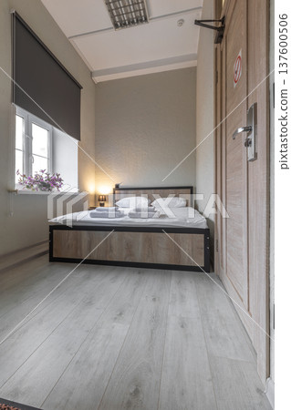 Compact Minimalist Hotel Room with Double Bed and Window Compact Minimalist Hotel Room with Double Bed and Window 137600506