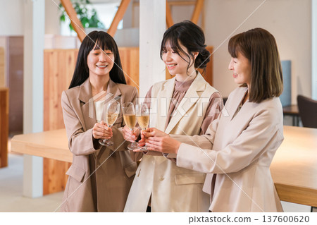 Businesswomen lining up in the office with champagne (teamwork, rally, victory party, celebration) Businesswomen lining up in the office with champagne (teamwork, rally, victory party, celebration) 137600620