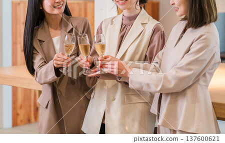 Businesswomen lining up in the office with champagne (teamwork, rally, victory party, celebration) Businesswomen lining up in the office with champagne (teamwork, rally, victory party, celebration) 137600621