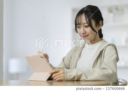 Female student studying with a tablet Female student studying with a tablet 137600666