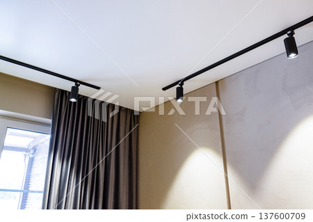 Living room ceiling with black spotlights on tracks Living room ceiling with black spotlights on tracks 137600709
