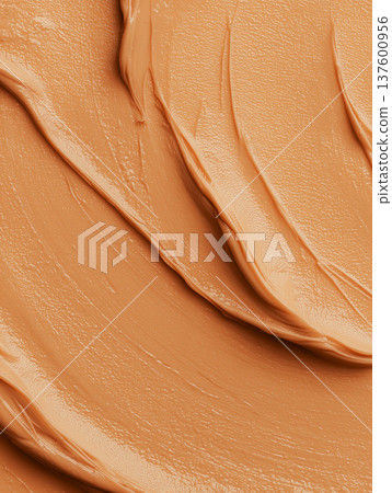 Creamy cosmetic smear in macro style on neutral cappuccino backdrop showing skincare texture with smooth detail concept Creamy cosmetic smear in macro style on neutral cappuccino backdrop showing skincare texture with smooth detail concept 137600956