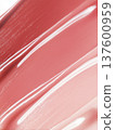 Glossy pink cosmetic smear shown in close macro style on a neutral backdrop, beauty product swatch and skincare concept 137600959