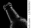 Chilled beer bottle covered in droplets shown in studio lights isolated on dark background with clipping path concept of freshness 137600967