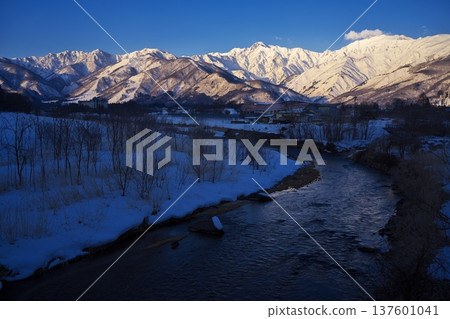 View of the Ushiro-Tateyama mountain range bathed in the morning sun from near Tenjinzaka in Hakuba Village in the dead of winter View of the Ushiro-Tateyama mountain range bathed in the morning sun from near Tenjinzaka in Hakuba Village in the dead of winter 137601041