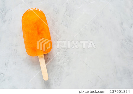 Orange ice cream lying on an gray background. 137601854