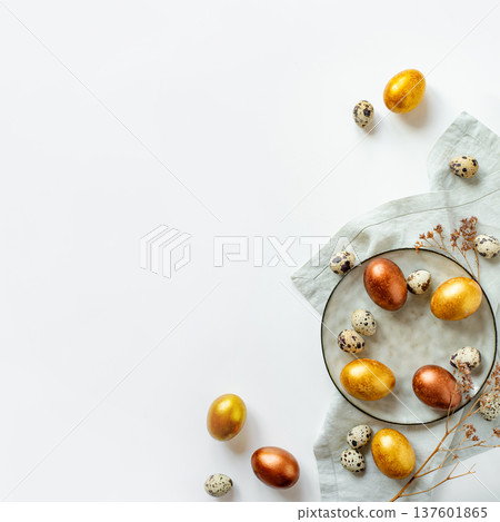 Golden and bronze Easter eggs in a grey plate Golden and bronze Easter eggs in a grey plate 137601865