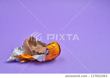 Open Broken Easter on Purple Background 137602063
