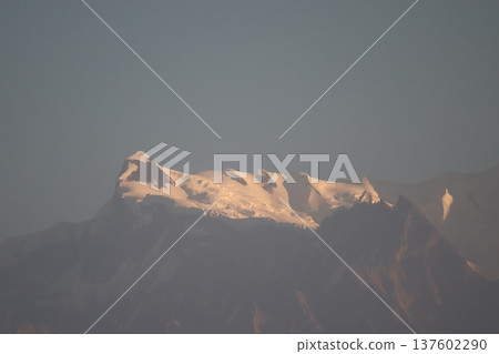 A glittering landscape of the snow-capped Himalayas lit by the morning sun A glittering landscape of the snow-capped Himalayas lit by the morning sun 137602290
