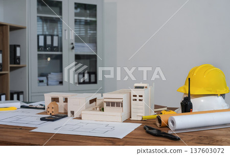 Construction house and building. workspace area. dof laptop computer and office construction on table in office blurred background, Architect concept. Construction house and building. workspace area. dof laptop computer and office construction on table in office blurred background, Architect concept. 137603072