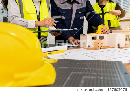 Team architect or engineer in office working on architects project. Team architect or engineer in office working on architects project. 137603076