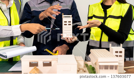 Engineer teams meeting working together wear worker helmets hardhat on construction site in modern city.Asian industry professional team Engineer teams meeting working together wear worker helmets hardhat on construction site in modern city.Asian industry professional team 137603077