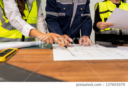 Engineer teams meeting working together wear worker helmets hardhat on construction site in modern city.Asian industry professional team Engineer teams meeting working together wear worker helmets hardhat on construction site in modern city.Asian industry professional team 137603079