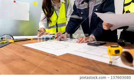 Engineer teams meeting working together wear worker helmets hardhat on construction site in modern city.Asian industry professional team Engineer teams meeting working together wear worker helmets hardhat on construction site in modern city.Asian industry professional team 137603080