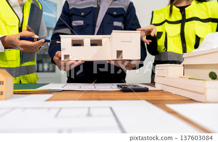 Engineer teams meeting working together wear worker helmets hardhat on construction site in modern city.Asian industry professional team Engineer teams meeting working together wear worker helmets hardhat on construction site in modern city.Asian industry professional team 137603084