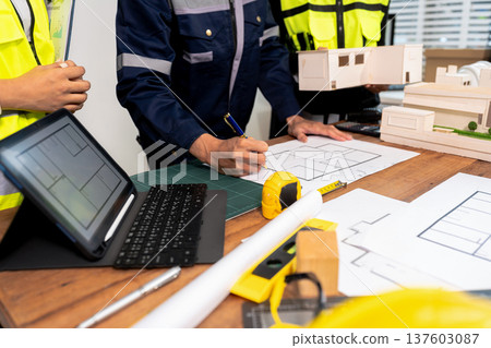 Engineer teams meeting working together wear worker helmets hardhat on construction site in modern city.Asian industry professional team Engineer teams meeting working together wear worker helmets hardhat on construction site in modern city.Asian industry professional team 137603087
