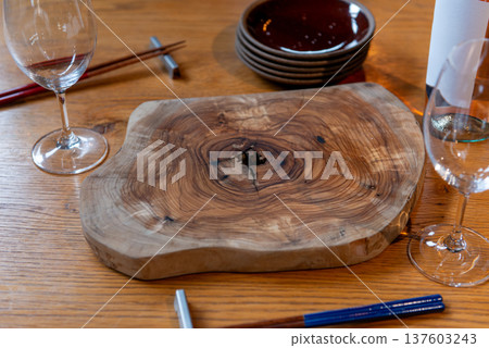 A cutting board and table set with beautiful natural wood rings 137603243