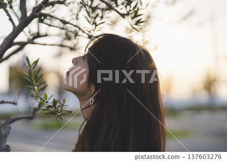 Woman looking at the sea at sunset Woman looking at the sea at sunset 137603276