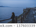 Woman looking at the sea at sunset 137603339