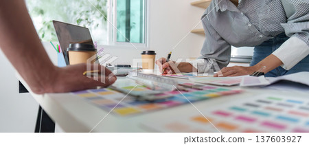 Architects working on design project with color samples and laptop 137603927
