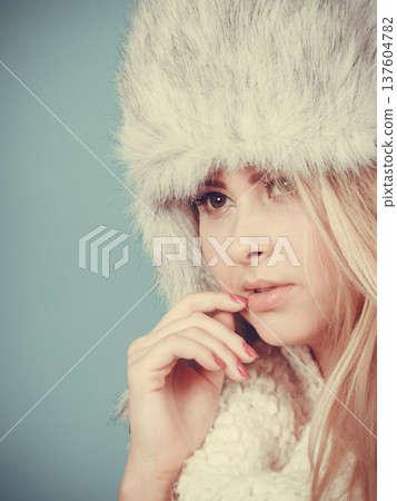 Blonde woman in winter warm furry hat Blonde woman in winter warm furry hat 137604782