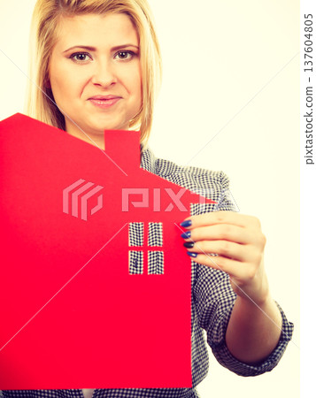 Woman holding red paper house symbol Woman holding red paper house symbol 137604805