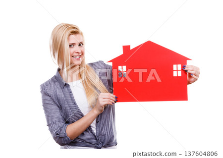 Woman holding red paper house symbol 137604806