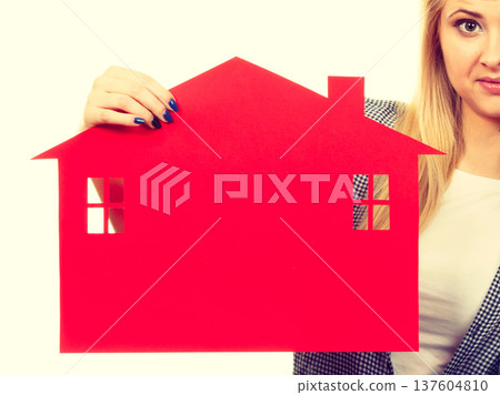 Happy woman holding red paper house 137604810