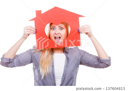Funny girl holding red paper house with heart shape Funny girl holding red paper house with heart shape 137604813