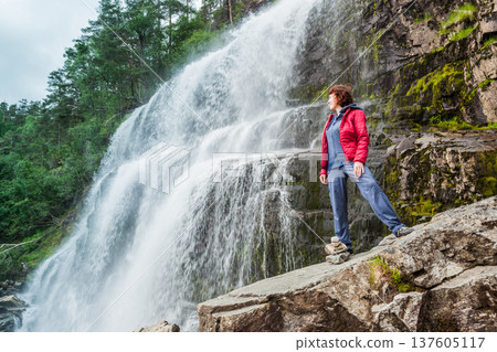 Tourist woman at waterfall Svandalsfossen, Norway 137605117