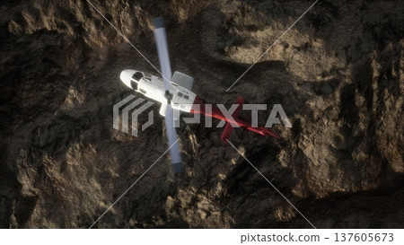 A helicopter hovers above rocky landscapes, its rotor blades spinning swiftly. Ground teams prepare for a critical mission to locate missing hikers. The rugged terrain presents challenges. 137605673