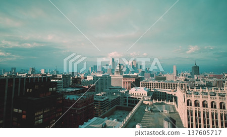rooftop city skyline dawn pastel light, historic brick buildings stretching toward distant metropolis, soft clouds and cinematic drone glide, warm tones rooftop city skyline dawn pastel light, historic brick buildings stretching toward distant metropolis, soft clouds and cinematic drone glide, warm tones 137605717